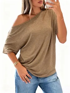 Detail of khaki off-shoulder short sleeve tee paired with light blue denim jeans