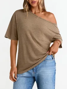 Close-up of tan off-shoulder T-shirt showing fine fabric texture and loose fit