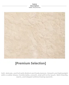 Close-up of soft cream faux fur fabric texture showing smooth fleece and warmth detail