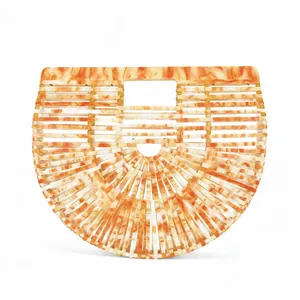 Detail view of the amber marble acrylic basket bag with its modern hollowed-out handle