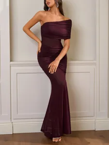 Detail of elegant burgundy one-shoulder ruched dress with slim fit mermaid hem