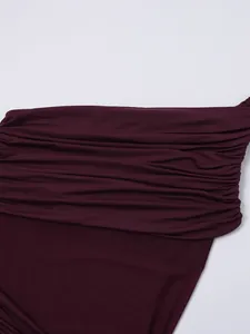 Detail view of burgundy mesh fabric and draped layers on a slim fit dress