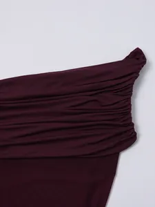Close-up of deep burgundy ruched mesh fabric with fine stitching and elastic texture