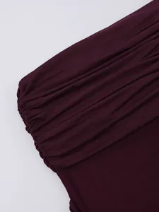 Detail of ruched mesh fabric and smooth knit texture in deep purple for dress