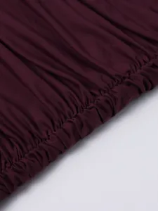 Detail of smocking elastic stitching on the burgundy mesh dress showing fine craft