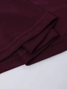 Macro shot of dark red mesh fabric and professional stitching on the dress edge