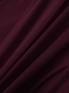 Detailed macro view of burgundy mesh fabric with elegant ruching and sheer texture