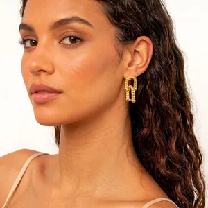 Textured gold horseshoe buckle earrings with vintage pleated geometric link design
