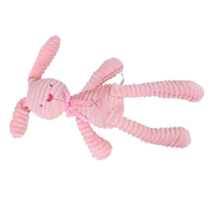 Pink corduroy bunny plush toy with long ears and ribbon bow on white background