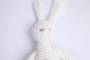 Close-up of plush bunny with textured corduroy fabric and minimalist embroidered face details