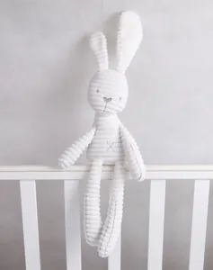 Close-up of white corduroy plush bunny with long ears and striped texture for infants