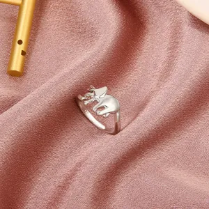 Macro shot of silver metal elephant ring placed on premium pink silk fabric background