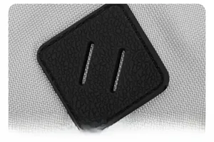 Close-up of black diamond leather patch on light gray fabric of casual backpack