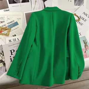 Back view of green blazer showing straight cut and four button cuffs on sleeve