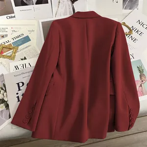 Detail view of burgundy blazer back with decorative sleeve buttons and smooth fabric