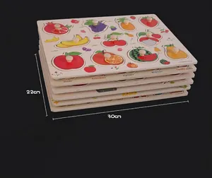 Macro detail of stacked wooden fruit puzzles for toddlers with small grab pegs