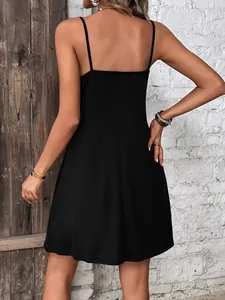 Back view of a black knitted mini dress with thin straps and open back design