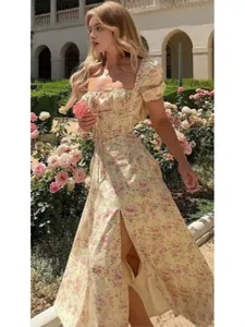 Floral print summer dress with puff sleeves and high slit in soft yellow floral pattern
