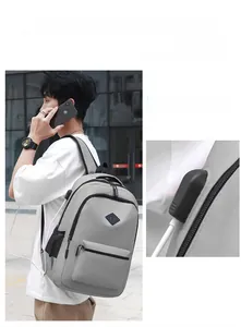 Detail showing an external USB charging port on a light gray travel backpack