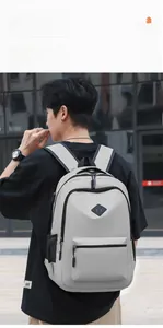 Outdoor lifestyle shot of a man wearing a light grey waterproof travel backpack