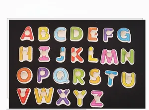 Macro detail of 26 uppercase alphabet wood puzzle pieces with knobs and stroke guides