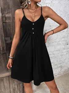 Detailed close-up of V-neck knitted dress with three decorative buttons and thin straps