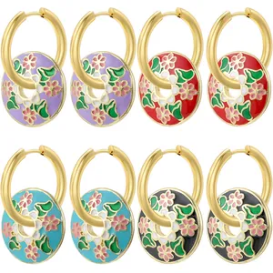 Detail of four colorful enamel daisy hoop earrings in purple, red, blue, and black
