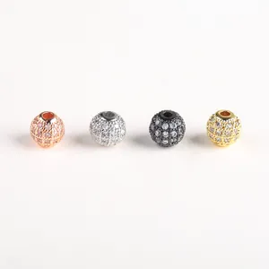 Detailed macro view of four micro-pave cubic zirconia round beads for DIY jewelry