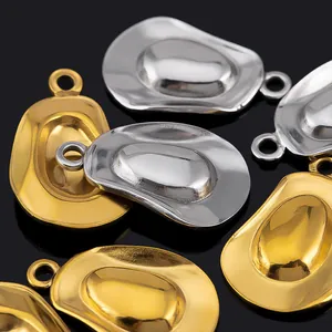 Macro view of polished gold and silver cowboy hat charms with secure top rings