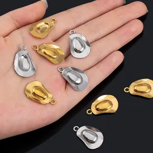 Detailed close-up of gold and silver cowboy hat charms for DIY jewelry making