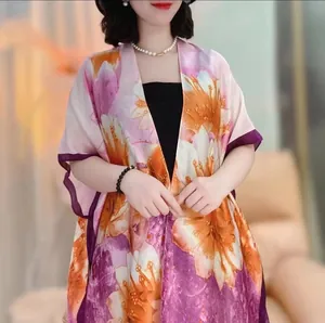 Detail of floral print satin sun protection shawl with elegant purple border trim