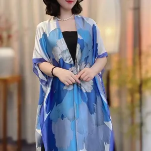 Close-up of floral print silk shawl showing premium texture and loose fit design