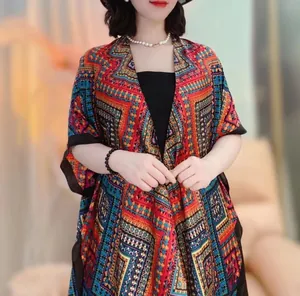 Detail of bohemian geometric print sun protection shawl with flowing satin fabric