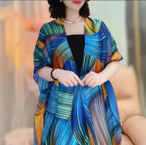 Close-up of lightweight satin sun protection shawl with vibrant artistic floral prints