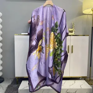 Detail of elegant purple silk shawl featuring floral prints and vintage bird motifs
