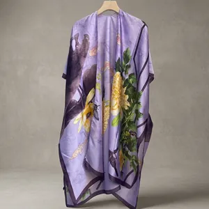 Detail of elegant purple silk shawl featuring floral prints and vintage bird motifs