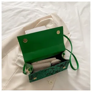 Internal view of green floral crossbody bag showing space for phone and wallet
