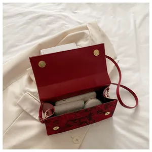 Detail view showing spacious interior of red crossbody bag with magnetic closures