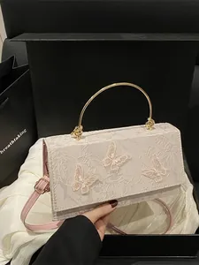 Beige embroidered square crossbody bag with butterfly patterns and gold round handle