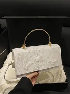 Elegant white floral embroidered handbag with golden circular handle and 3D butterfly decor