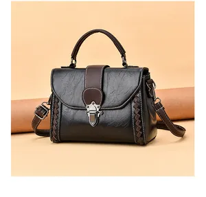 Detail of retro contrasting faux leather texture with hand-woven side stitching and silver lock