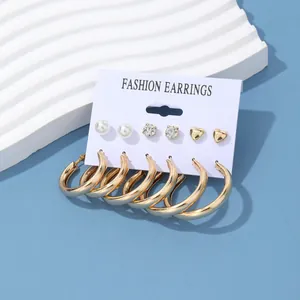 6-pair set of fashion hoop earrings with pearls, crystals, and gold hearts on display