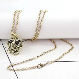 Vintage gold owl locket necklace with hollow pattern and long chain for aromatherapy