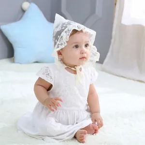 Detailed view of baby white lace dress and pointed hat set for newborn photography