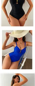 Close-up of ruched waist detail and elegant golden V-shaped buckle on one-piece swimsuit