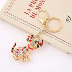 Detailed macro view of crystal-encrusted dalmatian dog keychain with gold finish