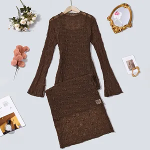 Detailed flat lay of brown lace long sleeve top and skirt set with vintage accessories