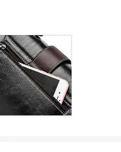 Close-up of the black lychee grain leather handbag with a back zipper pocket for phones