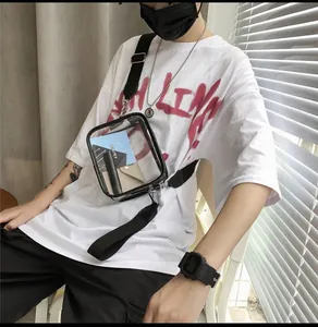 Detail of transparent PVC crossbody bag with black trim and adjustable shoulder strap