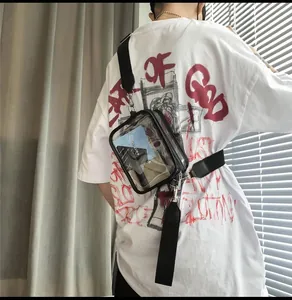 Detailed shot of transparent PVC crossbody bag with black trim and adjustable strap
